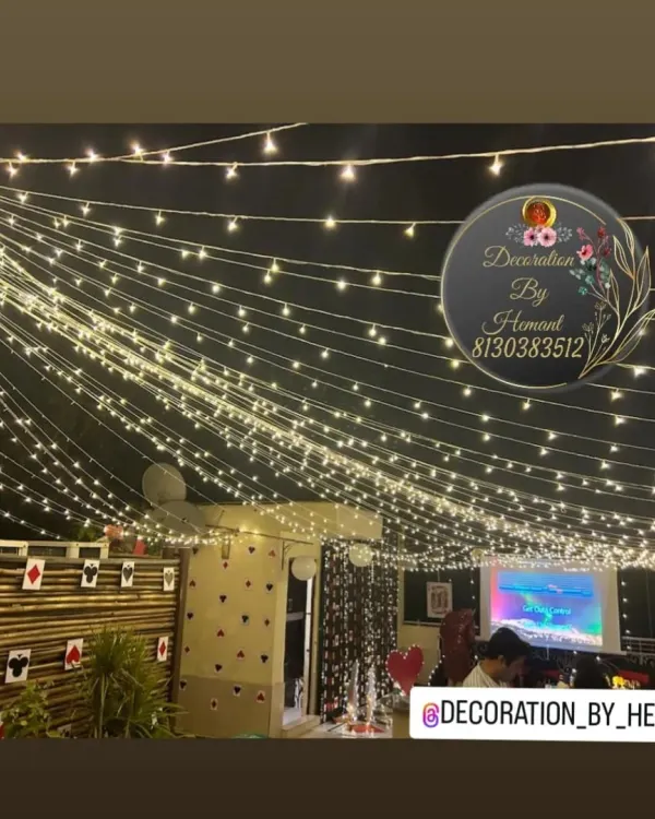 A canopy of fairy lights creating a magical ceiling for a terrace party. This lighting setup completely transforms an outdoor space, making it perfect for an evening celebration.