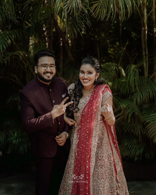 A fun and happy portrait of the couple, their playful gestures showing the joy of their engagement celebration.