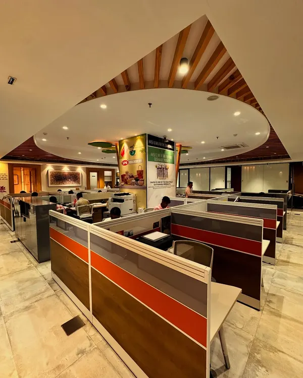 This wide view shows how the central 'tree of ideas' column integrates with the open-plan workspace. The design ensures that the company's core message of sustainability and growth is visible from every angle of the office floor.