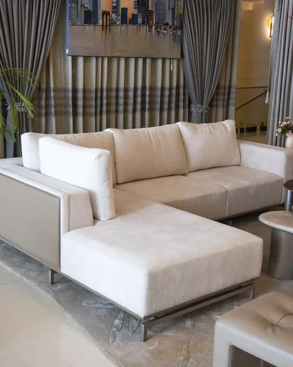 Simplicity meets contemporary design in our Oslo Sofa. We designed this piece with a sleek L-shape, upholstered in a combination of muted taupe leatherette and off-white fabric, to create a statement of modern comfort for any living room.