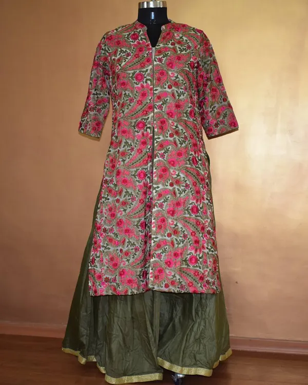 This long, front-slit kurta with a bold floral print is paired with a solid olive green skirt. It’s a comfortable yet striking outfit that perfectly blends Indian and Western aesthetics.