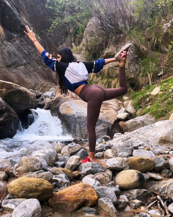 Finding my balance with Natarajasana (Dancer's Pose) by a waterfall. Practicing on uneven, natural surfaces adds an extra challenge and deepens your connection to the earth.