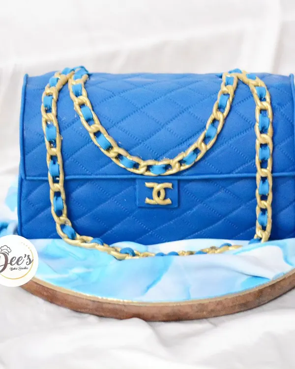 Why buy a Chanel bag when you can eat one? This realistic handbag cake is sculpted from cake and covered in quilted blue fondant with a detailed gold chain.