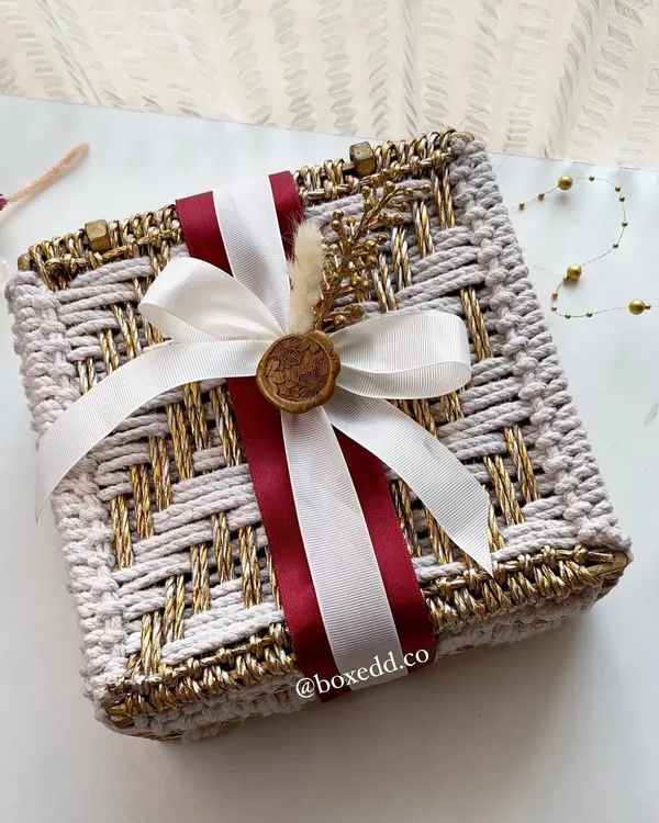 We design wedding invitations that set the tone for your entire celebration. This handcrafted woven box, finished with a custom wax seal, moves beyond a simple card to become a beautiful keepsake and the first taste of your wedding's aesthetic.