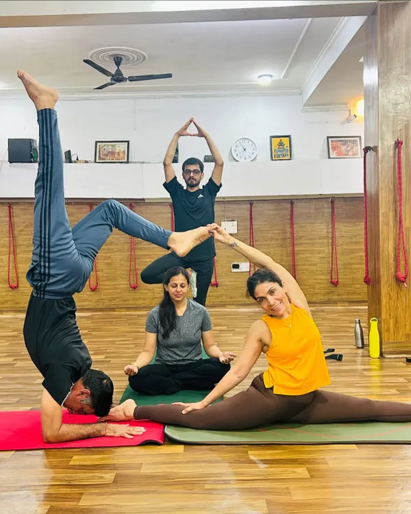 Yoga is better together. This creative group pose showcases the strength, balance, and connection of our students, blending individual focus with collective harmony.