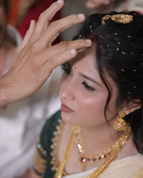 This close-up shows the flawless finish of the makeup during a wedding ritual. The skin looks smooth and radiant, not heavy or cakey, even under scrutiny.