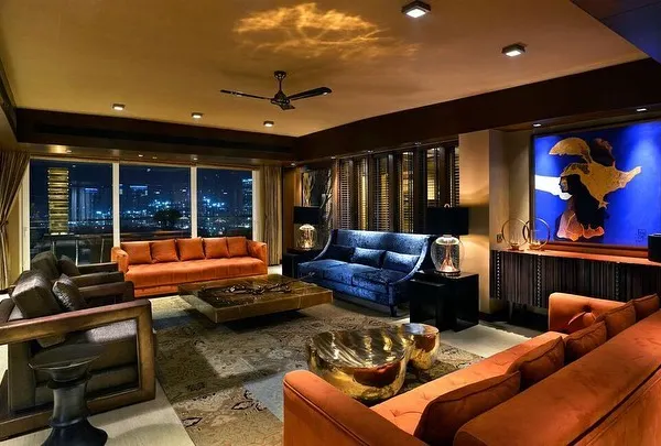 For this weekend home in Magnolias, Gurgaon, the goal was a heightened dramatic appeal. The living room is designed as an art object, with vibrant colours like deep orange and royal blue set against the glittering city skyline.