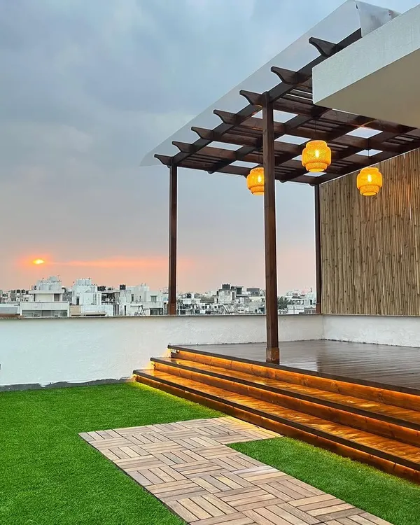 This complete terrace makeover combines a Thermopine wood pergola, a multi-level deck with integrated step lighting, and maintenance-free artificial grass to create a stunning rooftop escape.