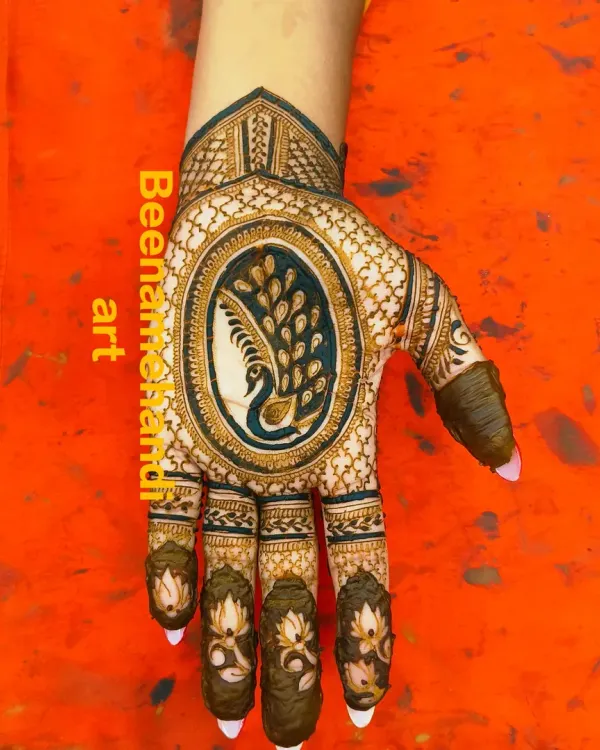 A stunning design with a large peacock as the centerpiece on the back of the hand. The fingers are decorated with delicate lotus motifs.