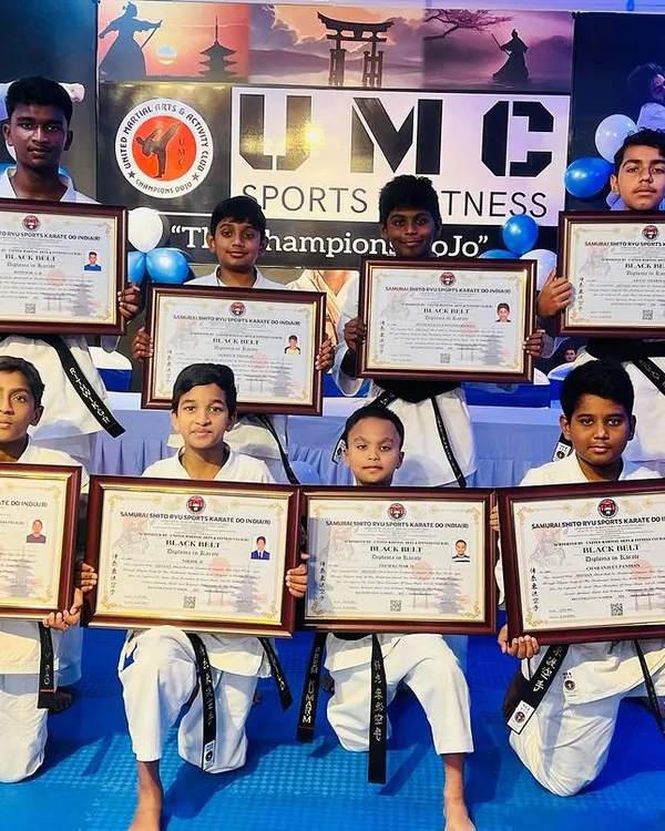Our newest group of black belt recipients proudly display their hard-earned certificates. This is a huge milestone in their martial arts journey.