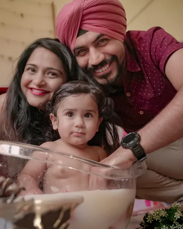 A happy family enjoying a fun milk bath photoshoot at home. This is a great example of a creative and playful themed session I can set up right in your living room.