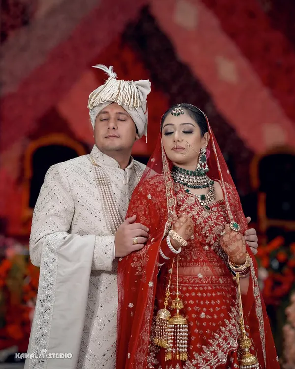 A serene and intimate moment between the bride and groom during their wedding ceremony, their eyes closed in quiet reflection.