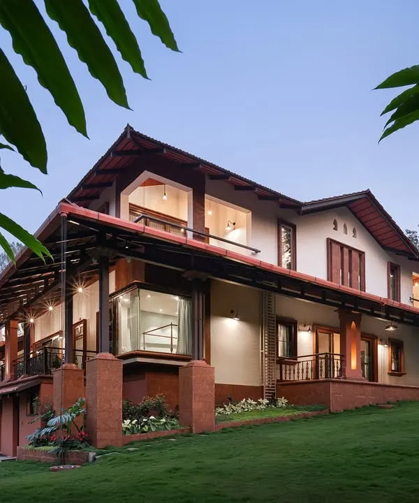 This Coorg estate glows at twilight, its laterite stone base and terracotta tile roof deeply connected to the earth. I designed this home to breathe with the land, where large glass corners and open verandas invite the surrounding forest and mist inside, creating a sanctuary for slow, mindful living.