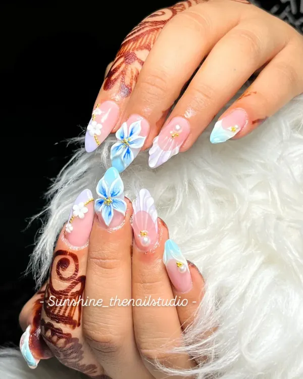 This is the kind of detailed work I live for. This set features hand-sculpted 3D acrylic flowers in soft blue, accented with delicate pearls and gold details, perfect for a bride or any special celebration.