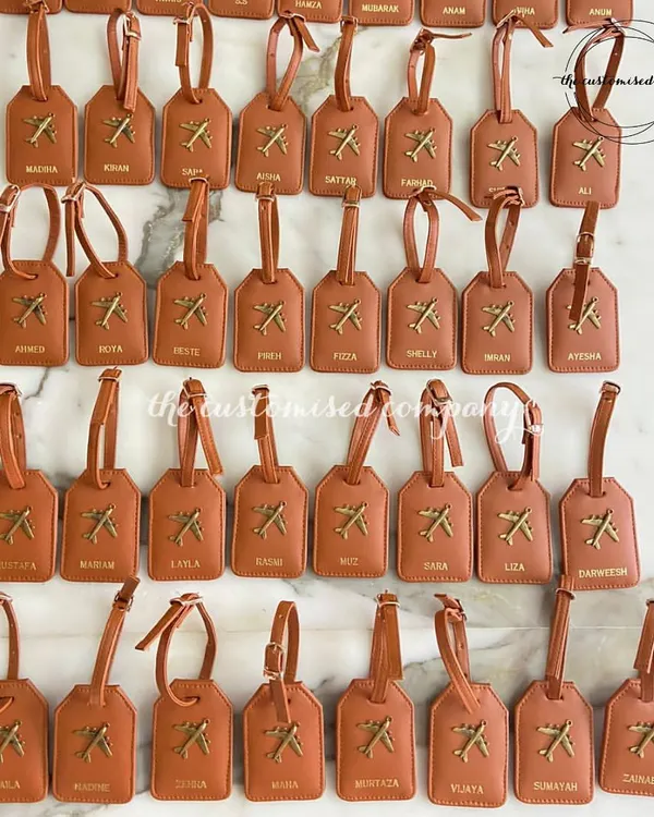 Gearing up for a big group trip? This image shows a large order of personalized vegan leather luggage tags, each customized with a name. It’s a great way to keep luggage organized and easily identifiable.