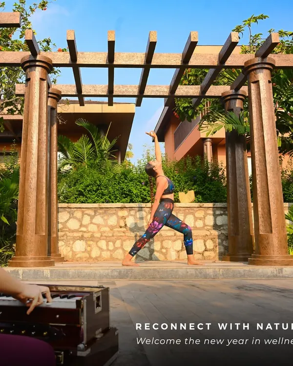 A guest finds her balance in a warrior pose during an outdoor yoga session. Practicing on our deck, surrounded by the resort's architecture and gardens, adds a unique element of grounding and inspiration to your flow.