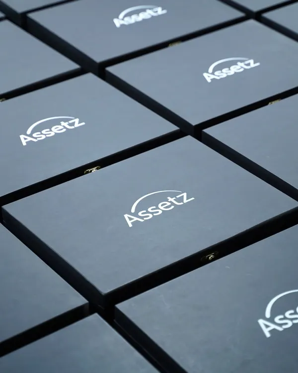 Your brand, front and center. Here are some custom wooden boxes I created for Assetz, featuring their logo prominently. This is a great way to make a lasting impression with your corporate gifts.