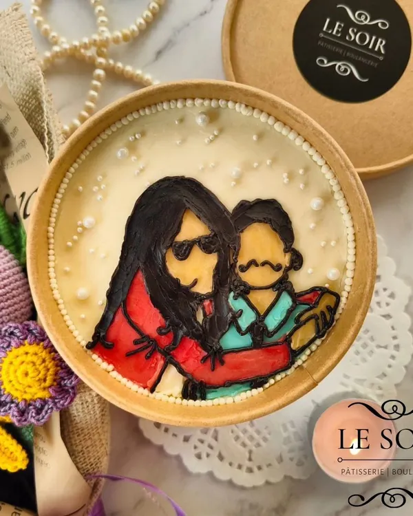 Your special moments, illustrated on a cake. This custom portrait cake tub was a joy to create, capturing a sweet memory in edible art, complete with delicate pearl borders.