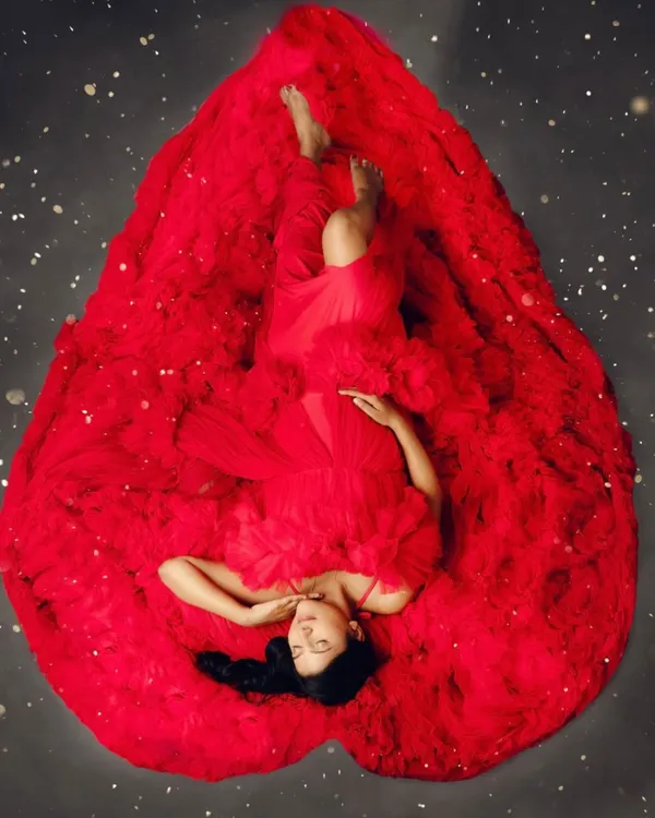 This is one of my favorite portraits, where the gown itself becomes a symbol of the immense love surrounding you and your baby. It's a moment of pure art and emotion, celebrating the heart of motherhood.