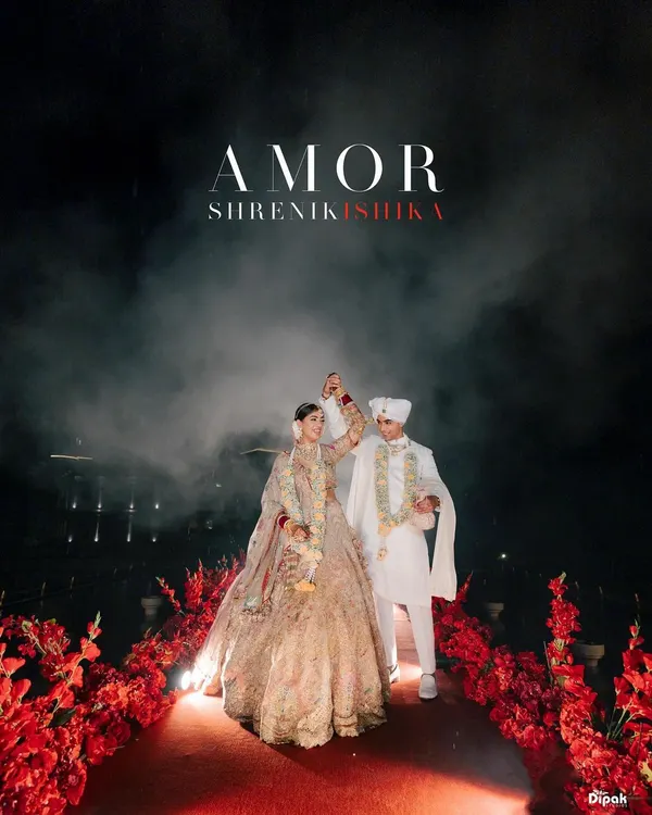 Therein lies a love that commands the grandest stage. For this couple, their wedding aisle was not just a path but a declaration, lined with a sea of crimson florals under the vast night sky. It is in these moments of monumental beauty that I find the true essence of a royal romance.