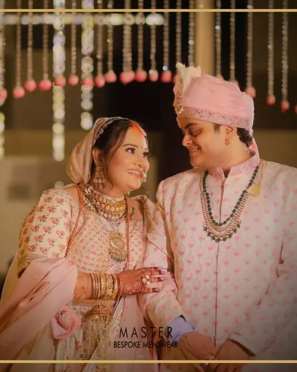 A beautiful moment between the happy couple. Our groom Mihir wears a custom-designed pink printed sherwani that perfectly complements the bride's attire and the wedding's color palette.