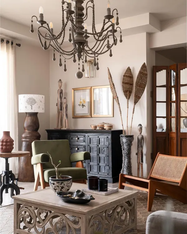 This living room embodies the Wabi-Sabi philosophy, filled with pieces that have a story. We mixed a vintage-style chandelier with tribal art and rustic wooden furniture to create a space that feels collected and personal.