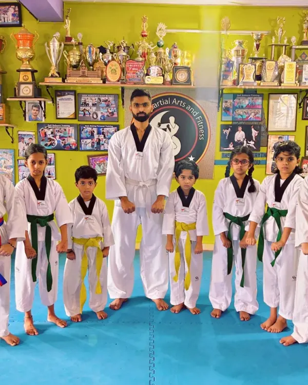 A group of our young Taekwondo students with their coach. We are proud of our growing team.