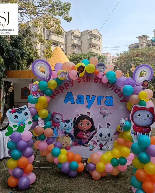 This colorful Gabby's Dollhouse theme was a delight to create for Aayra's 5th birthday. The outdoor setup featured a custom circular backdrop with all her favorite characters, surrounded by a vibrant balloon arch.