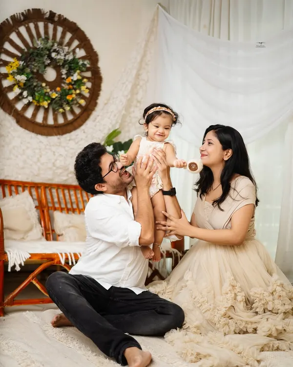 A beautiful family portrait, with mom and dad lifting their little girl up in a moment of pure joy. These are the candid, love-filled shots that become treasured heirlooms.