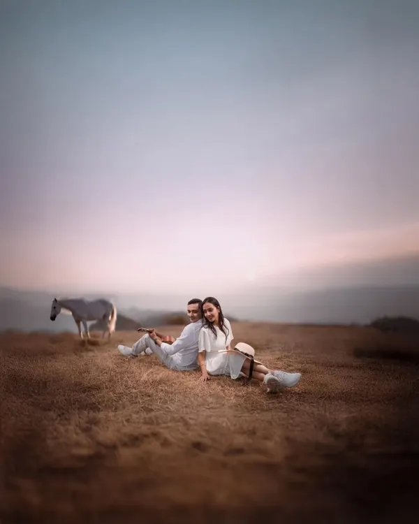 I believe every love story deserves a grand canvas. For Atul and Rachita, we found this serene pasture at dusk, creating a moment that feels like a painting. The quiet presence of the horse adds a touch of magic to their peaceful embrace.
