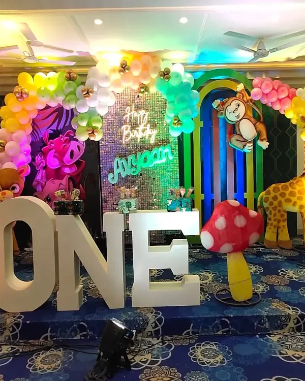 A vibrant jungle theme for a first birthday celebration. I created this entire setup with large animal props, a colorful balloon arch, and a custom neon sign to bring the wild adventure to life.