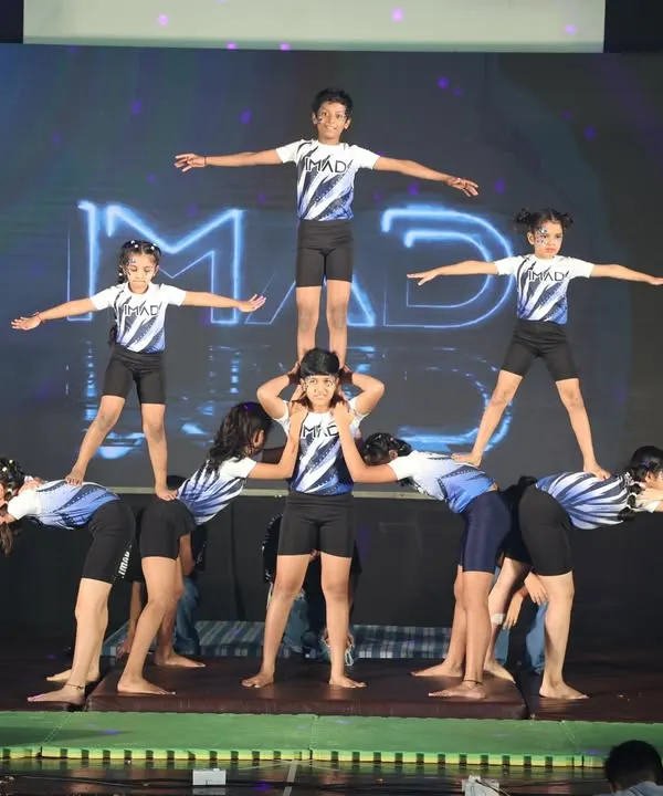 This is what teamwork looks like at IMAD. Our students learn to trust and support each other to create amazing human pyramids and group formations, building both physical strength and strong friendships.