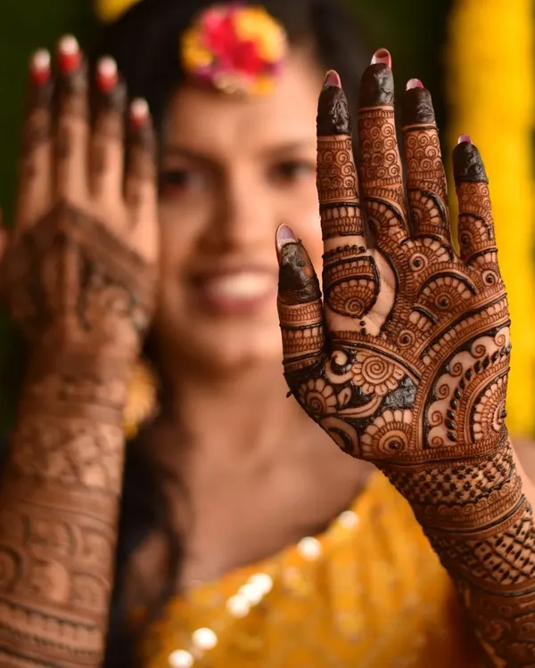 This is what pure joy looks like! I love capturing the happiness of a bride on her mehendi day. This intricate design, filled with traditional motifs, is a perfect match for a radiant bride ready for her big celebration.