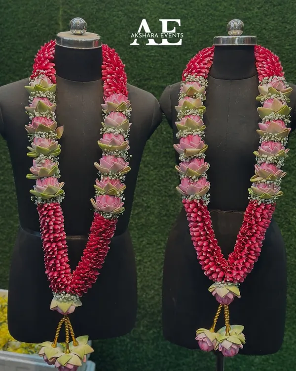 A matching set of wedding garlands (varmala) handcrafted for a couple. I used rose petals and my signature pink lotus buds, finished with delicate Baby's Breath and traditional golden tassels for an elegant look.