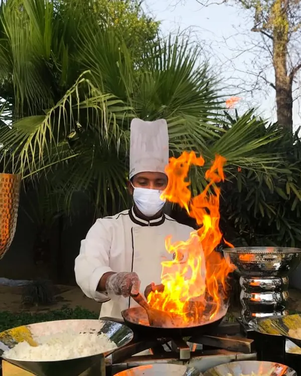 There is nothing more captivating than the theater of live cooking. Here, one of our chefs creates a dish with a dramatic flair of fire, adding an element of excitement and spectacle to the dining experience.