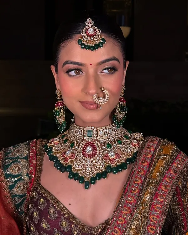 This is the complete royal bridal look you dream of. This stunning Kundan and Polki choker set, complete with matching maang tikka, earrings, and nath, is crafted to make you feel like a queen on your wedding day.