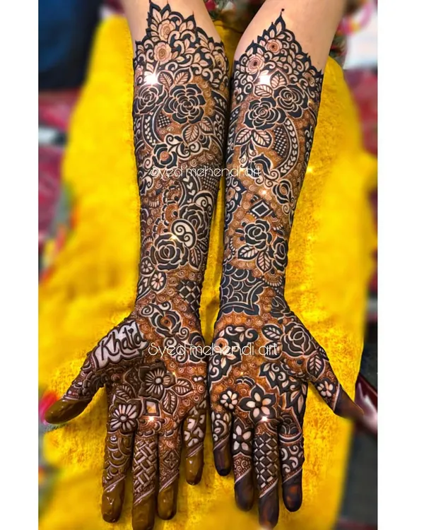 A complete bridal henna look, showcasing the level of detail and coverage I love to provide. This design features a dense mix of traditional Indian motifs, including paisleys and florals, extending up to the elbows for a truly grand statement.