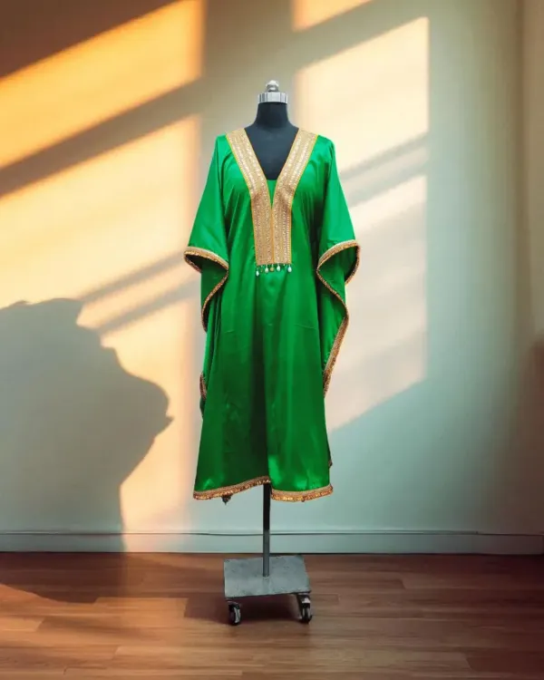 This stunning emerald green kaftan shines in soft satin, with a beautiful gold embroidered neckline. It's a comfortable yet luxurious choice for any festive celebration.