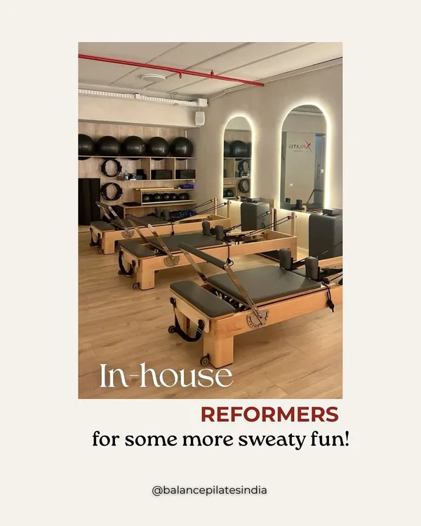 A look at our in-house reformers, all lined up and ready for some sweaty fun. We manufacture our own equipment to ensure it's sturdy, smooth, and supportive.