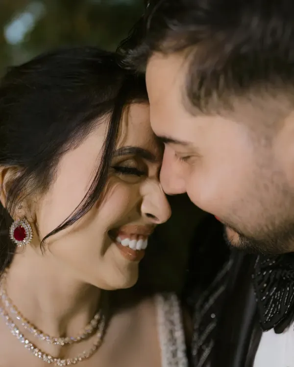A close-up that speaks of pure happiness. This is the energy of a Sangeet night, a celebration of love where every smile shines brighter than the lights.