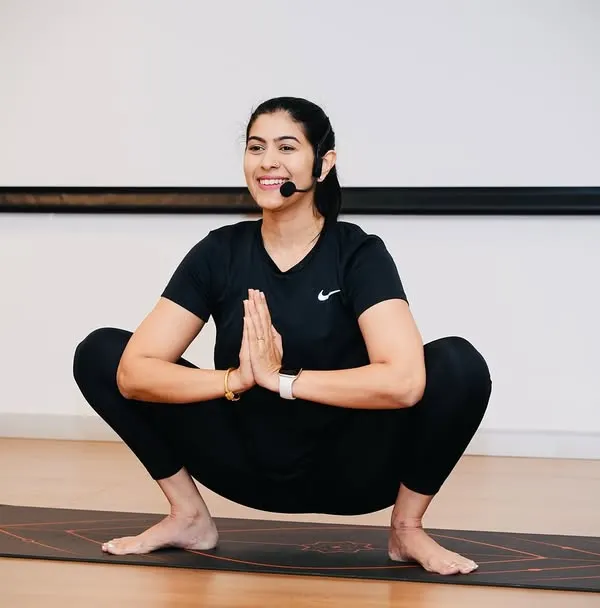 The Malasana, or yogic squat, is a fantastic pose for office workers as it helps open up the hips and improve posture. I guide employees through each step, ensuring proper form and accessibility for everyone.