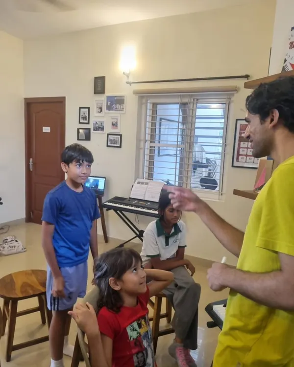 An instructor guiding students through a music concept. These small group interactions are key to ensuring every child gets the attention they need to understand and grow.
