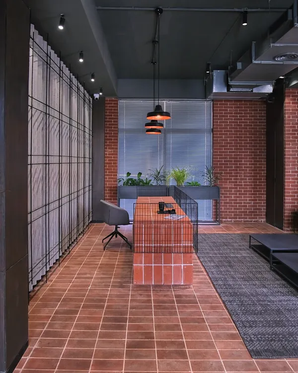 The reception for the student housing at Jaipuria Institute of Management, Noida. The design uses raw, honest materials like exposed brick and terracotta tiles to create a warm, grounded, and inspiring atmosphere for students.
