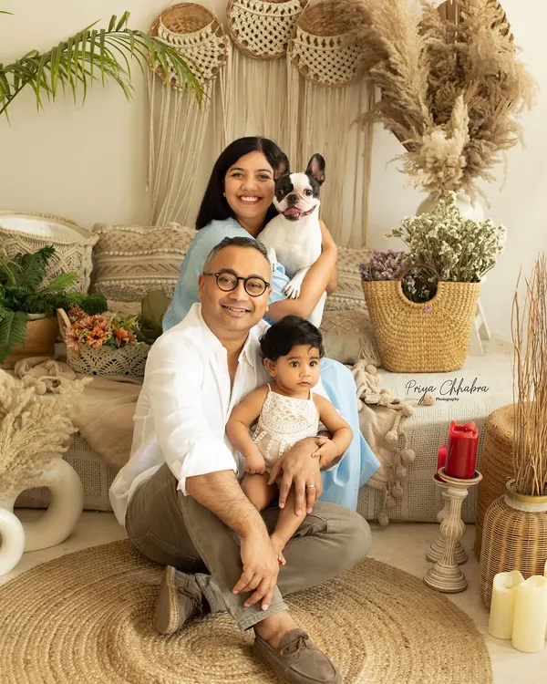 Because every family portrait is better with a furry friend! This family of three becomes a family of four with their adorable French bulldog joining the studio session.