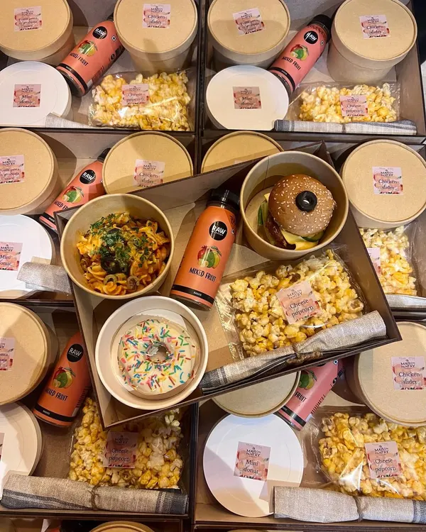 An inside look at one of my custom food boxes for a kid's birthday party. This box contains a balanced and fun meal: fusilli arrabbiata pasta, a mini slider, cheese popcorn, a sprinkle donut, and a mixed fruit juice.