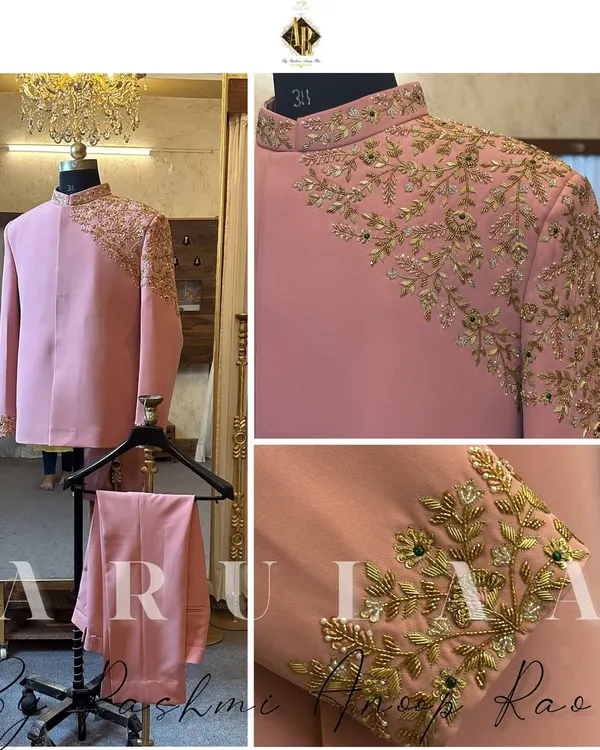 This blush pink Jodhpuri suit is a perfect example of modern royalty. The asymmetrical cut is paired with stunning gold zardosi embroidery that flows from the shoulder down the sleeve and cuff, creating a truly unique piece for a groom.