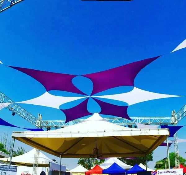 This is how I transform an open field into a vibrant festival space. This custom fabric canopy installation in Pune provided both shade and a stunning visual centerpiece for the Times Now food festival, using a dynamic pattern of purple and white sails against the sky.