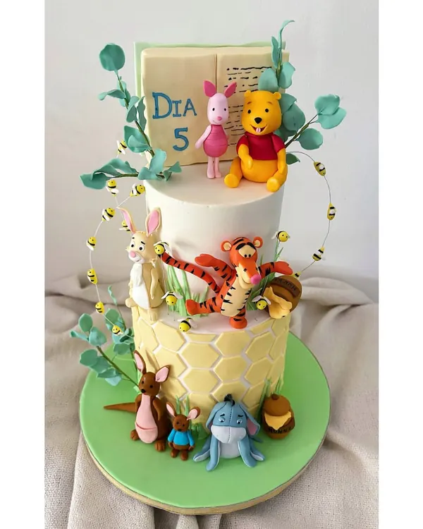 It was pure joy to recreate the world of Winnie the Pooh for a fifth birthday. Every character, from Pooh to Eeyore, was handcrafted from fondant, turning a delicious chocolate hazelnut cake into a storybook scene.