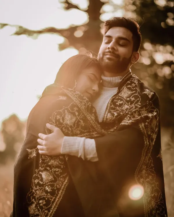 A warm, intimate hug during golden hour in Shimla. The soft sunset light and the authentic emotion in this pre-wedding photo make it a perfect memory of a mountain getaway.