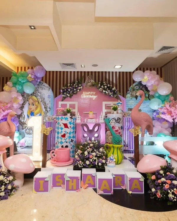 I believe in creating a complete world for your child to step into. This 'Alice in Onederland' setup shows how I use large custom backdrops, themed props like giant mushrooms and character cutouts, and personalized name blocks to make the main stage a breathtaking centerpiece.